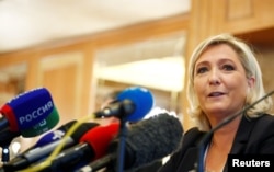FILE - Leader of France's National Rally Party Marine Le Pen speaks during a news conference in Milan, Italy, May 18, 2019.