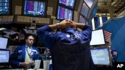 Traders work on the floor of the New York Stock Exchange on Thursday, Aug. 4, 2011