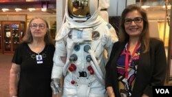 Sandra Cauffman, right, serves as deputy director of NASA's Earth Science division. She's shown at agency headquarters with her mother, María Jerónima Rojas, and an Apollo space suit.