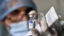 A medical worker holds a vial of Russia's Sputnik V vaccine for COVID-19 coronavirus disease at a clinic in the city of Blida, about 45 kilometres southwest of the Algerian capital, on January 30, 2021