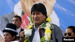 FILE - Bolivia's President Evo Morales attends the inauguration of multifamily buildings decorated by painter Roberto Mamani and built by a housing program government in El Alto, on the outskirts of La Paz, Bolivia, Feb. 15, 2016. 