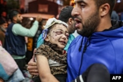 FILE —Injured Palestinians evacuated from the Indonesian hospital in the north of the Gaza Strip receive care at Nasser hospital in the Palestinian territory's southern city of Khan Yunis, on November 20, 2023.