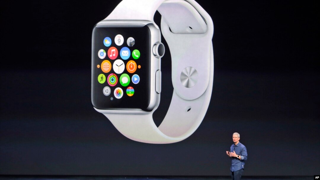 FILE - Apple CEO Tim Cook introduces the new Apple Watch on Tuesday, Sept. 9, 2014, in Cupertino, Calif. Apple's new wearable device marks the company's first major entry in a new product category since the iPad's debut in 2010.