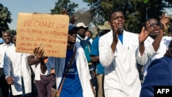 FILE - Doctors and medical staff march to Zimbabwe's Parliament, Sept. 19, 2019, in Harare demanding the safe return of Peter Magombeyi, whom protesters believe was taken because of his role organizing strikes to demand better pay and working conditions.