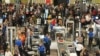 Travelers wade through the south security checkpoint in Denver International Airport, Dec. 19, 2024, in Denver, Colorado.