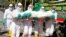 Health workers of the Indonesian police force carry a dummy as they train volunteers how to handle remains of COVID victims, at Manahan Stadium in Solo, Central Java province, Indonesia July 6, 2021. (Antara Foto/Maulana Surya/via Reuters)