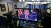 President Donald Trump is seen on monitors in the briefing room of the White House, as he gives a prime-time address in the Oval Office, Jan. 8, 2019.