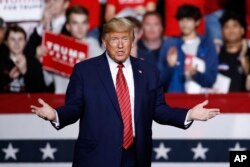 FILE - President Donald Trump walks onstage to speak at a campaign rally, Feb. 28, 2020, in North Charleston, S.C.