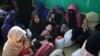 FILE - Rohingya refugee women wait outside of a medical center at Jamtoli camp in Cox's Bazar, Bangladesh, Jan. 22, 2018. 