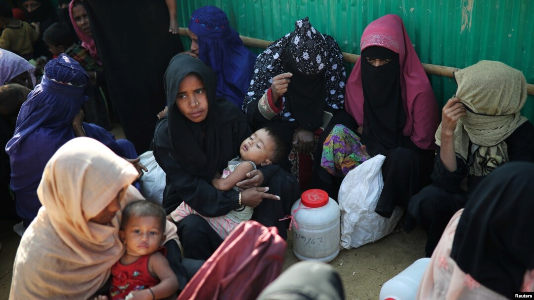 FILE - Rohingya refugee women wait outside of a medical center at Jamtoli camp in Cox's Bazar, Bangladesh, Jan. 22, 2018. 