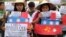 FILE - Filipino student activists hold mock Chinese ships to protest recent island-building and alleged militarization by China off the disputed Spratlys group of islands in the South China Sea, during a rally in Manila, Philippines, March 3, 2016.