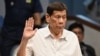 Former Philippine president Rodrigo Duterte takes an oath as he attends a senate probe on the drug war during his administration, in Manila on October 28, 2024.