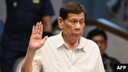 Former Philippine president Rodrigo Duterte takes an oath as he attends a senate probe on the drug war during his administration, in Manila on October 28, 2024.