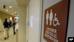 FILE - A sign marks the entrance to a gender-neutral restroom at the University of Vermont in Burlington, Vermont, Aug. 23, 2007.