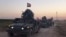 This image made from a video shows Iraqi soldiers on military vehicles in the Qatash area moving towards Kirkuk gas plant, Oct. 16, 2017.