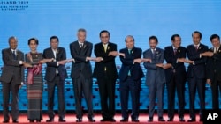 In this June 23, 2019, file photo, South East Asian leaders pose for a group photo during the opening ceremony of the ASEAN leaders summit in Bangkok, Thailand. (AP Photo/Gemunu Amarasinghe, File)