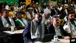 FILE - South African President Cyril Ramaphosa, first row left, listens in Johannesburg, Friday, Jan 26, 2024 to the ruling from the top U.N. court that harshly criticized Israel's war against Hamas.