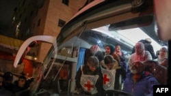 Palestinian prisoners (back) hold   to disembark from a Red Cross autobus  upon their accomplishment  successful  the occupied West Bank municipality  of Beitunia, connected  the outskirts of Ramallah, pursuing  their merchandise  by Israel successful  the aboriginal  hours of Jan. 20, 2025.