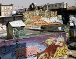 FILE - In this Feb. 22, 2006, photo, the 7 Train passes by the 5 Pointz Building in Long Island City, Queens, New York.