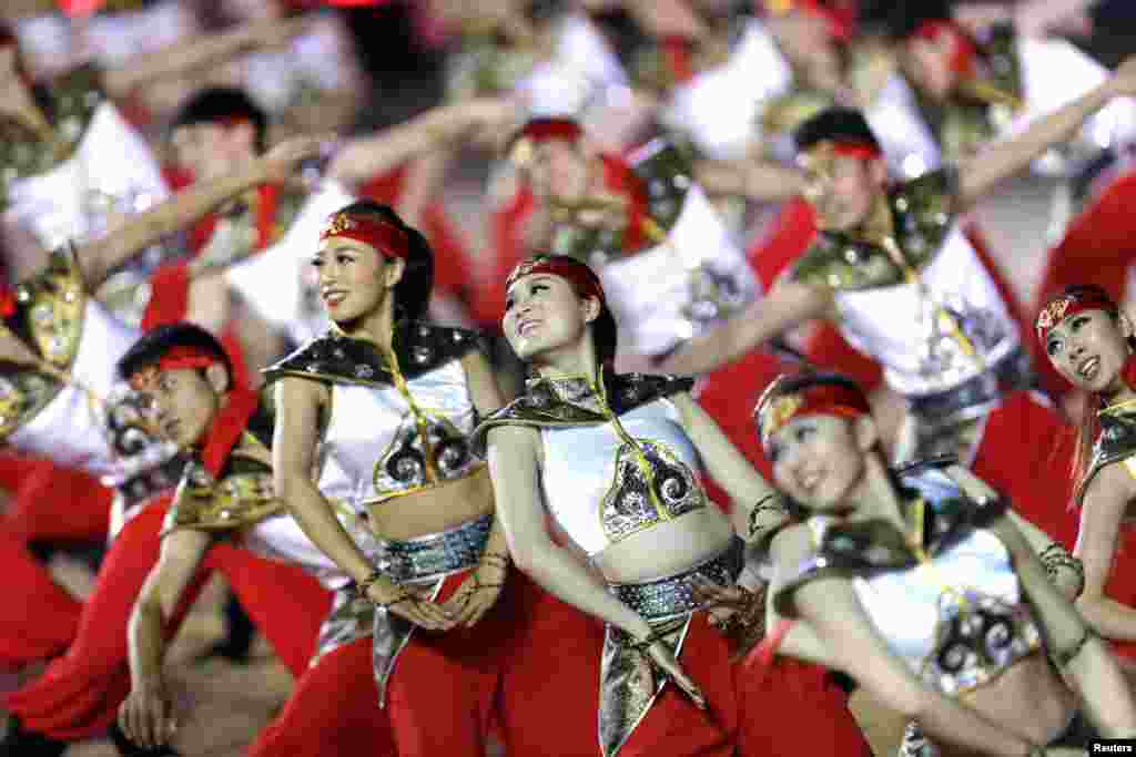 Chinese dancers perform for the opening ceremony of 2014 International Akhal-Take Horses Association Special Conference and China Horse Culture Festival in Beijing.