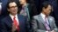 U.S. Treasury Secretary Steve Mnuchin waves next to Japan's Deputy Prime Minister and Finance Minister Taro Aso at the International Monetary Fund Governors family photo during the IMF/World Bank spring meeting in Washington, April 21, 2018.
