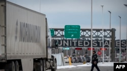 A truck drives on its way to enter the United States at a border crossing at the Canada-US border in Blackpool, Quebec, Canada, on Feb. 2, 2025.