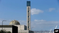 FILE — Cars drive past the The Djamaa El-Djazair, or Algiers Great Mosque, February 21, 2024 in Algiers. Begun in 2012, the Great Mosque of Algiers boasts a giant 265 meter (290 yard) minaret and a capacity for 120,000 faithful.