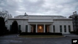 FILE - A view of the West Wing of the White House, dark on Sunday, Jan. 21, 2018, in Washington.