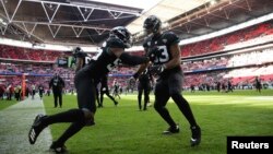 Players for the Jacksonville Jaguars prepare for an NFL game against Philadelphia Eagles at Wembley stadium in London, Oct. 28, 2018.
