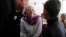 Christine Lagarde (C), International Monetary Fund Managing Director, speaks to a Syrian refugee student at Alimate school in Mafraq, Jordan, May 11, 2014. 