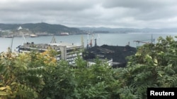 FILE - Piles of coal are seen in the Astafyev Cape area of the far eastern port of Nakhodka, Russia Sept. 5, 2017. 