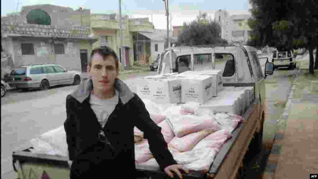 This undated photo shows Peter Kassig leaning against a truck at an unknown location.