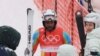 Skier Shannon Ogbnai-Abeda of Eritrea reacts after completing his run during the men's giant slalom event at the Winter Olympics, Feb. 13,2022.
