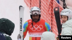 Skier Shannon Ogbnai-Abeda of Eritrea reacts after completing his run during the men's giant slalom event at the Winter Olympics, Feb. 13,2022.
