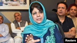 FILE - Former Jammu and Kashmir Chief Minister Mehbooba Mufti gestures as she addresses a news conference in Srinagar, June 19, 2018.