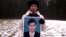 Chea Vichea's wife holding a picture of her late husband, Chea Vichea, file photo. 