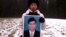 Chea Vichea's wife holding a picture of her late husband, Chea Vichea, file photo. 