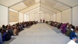 Afghan refugees eat lunch at a registration center upon their arrival from Pakistan at the Afghanistan-Pakistan border in Spin Boldak district of Kandahar province on Dec. 3, 2023.