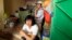 Chinese vendors wait for customers inside their shop at a local market in Omdurman, Sudan, Jun. 6, 2013.