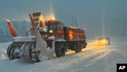 This Dec. 31, 2022, photo released by Caltrans District 3, California Department of Transportation crews clear the road on Highway 50 over Echo Summit for avalanche control work in South Lake Tahoe, Calif.