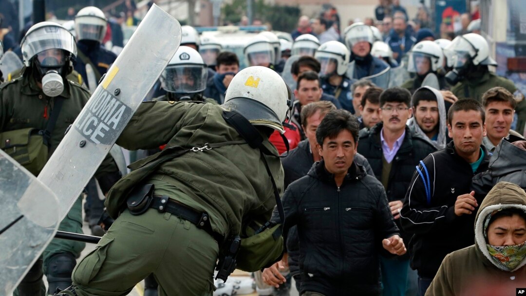 Riot police scuffle with migrants during a protest in Mytilene port on the northeastern Aegean island of Lesbos, Greece, on Tuesday, Feb. 4, 2020. Asylum seekers have demonstrated for a second day on the Greek island of Lesbos amid rising tension,…