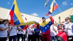 Dozens of demonstrators chant and wave Venezuelan flags in Doral, Florida, Feb. 18, 2014.