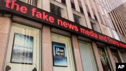 News headlines scroll above the Fox News studios in the News Corporation headquarters building, in New York, Aug. 1, 2017.