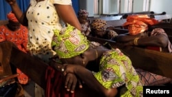 Churchgoers pray for the release of schoolgirls abducted from the village of Chibok at an Evangelical Church of West Africa (ECWA) church in Abuja, Nigeria, May 11, 2014. 