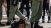 FILE - Riot police detain a man as they clear protesters taking part in a rally against a new national security law in Hong Kong on July 1, 2020.