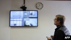 French researcher Laurent Vinatier appears on a screen via a video link during a hearing of an appeal against his prison sentence he was handed in October, at the Moscow City Court, Feb. 24, 2025. 