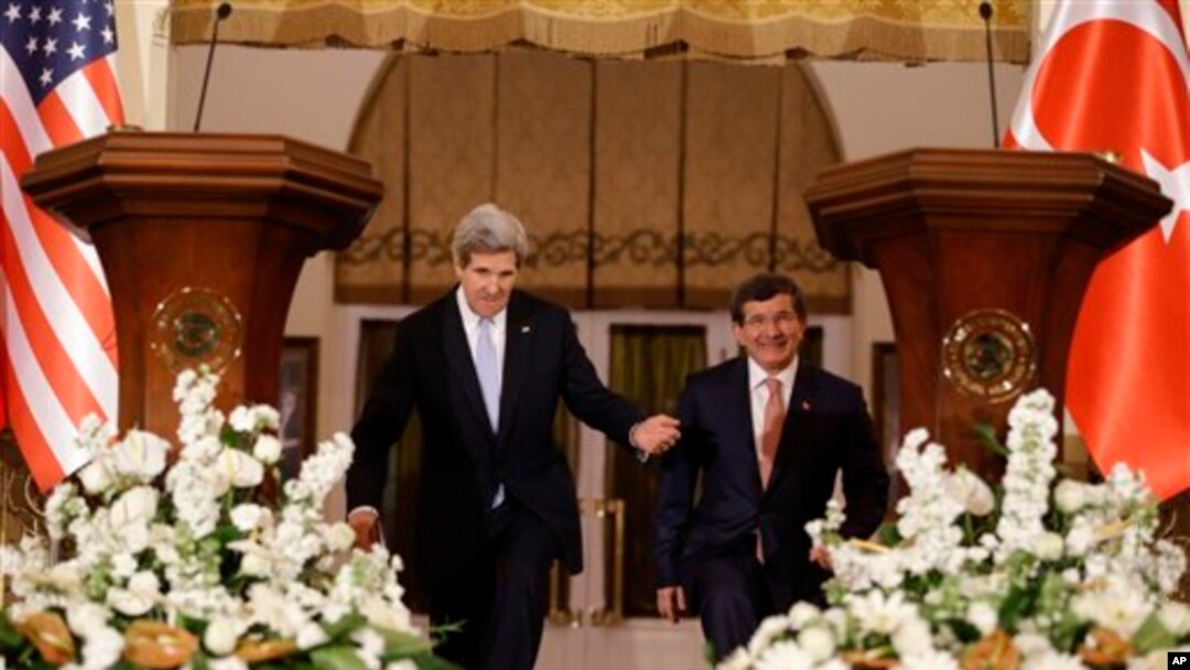 U.S. Secretary of State John Kerry, left, enters a news conference with Turkish Foreign Minister Ahmet Davutoglu in Ankara, Turkey, on March 1, 2013.