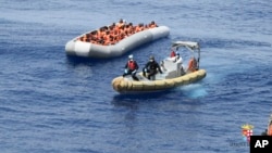 This undated image made available on May 30, 2016, by the Italian Navy Marina Militare shows migrants being rescued at sea. The Greek Coast Guard has pulled to safety 29 migrants afloat in a dinghy off the western island of Lefkada, as they headed to Italy.