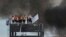 Inmates at the Puraquequara prison stand on a water tower as they protest against bad conditions and restrictions on family visits put in place to curb the spread of the new coronavirus in Manaus, Brazil, May 2, 2020. 