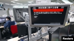 In this photo by Kyodo, a TV in Tokyo, April 13, 2023 displays a warning message that reads: Japanese government warns citizens of the northernmost main island of Hokkaido to take immediate cover and stay inside buildings, saying a missile was likely to fall near the island.